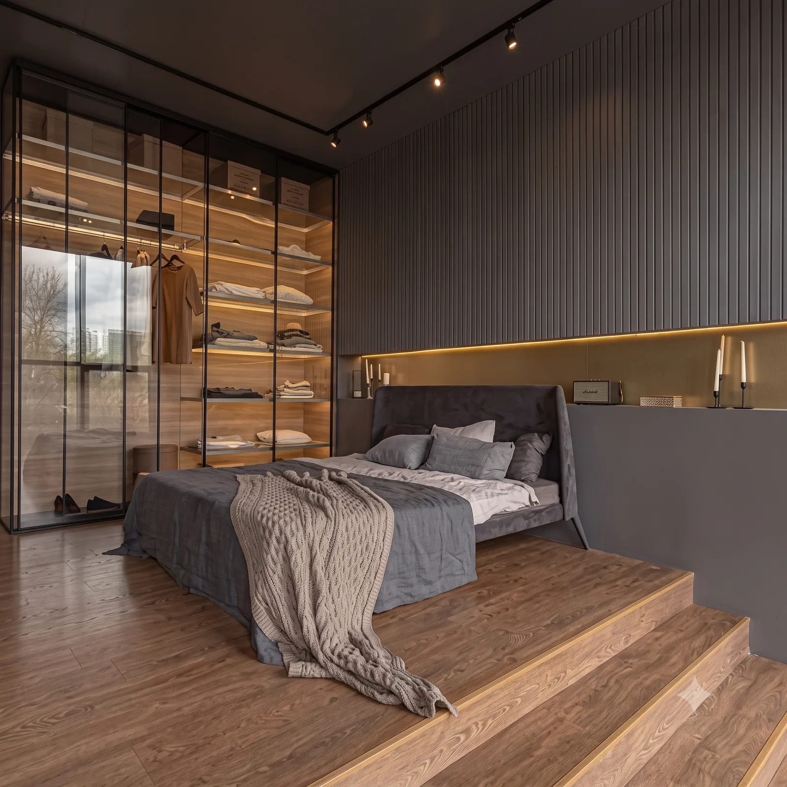 Platform bed beside a glass-walled dressing room
